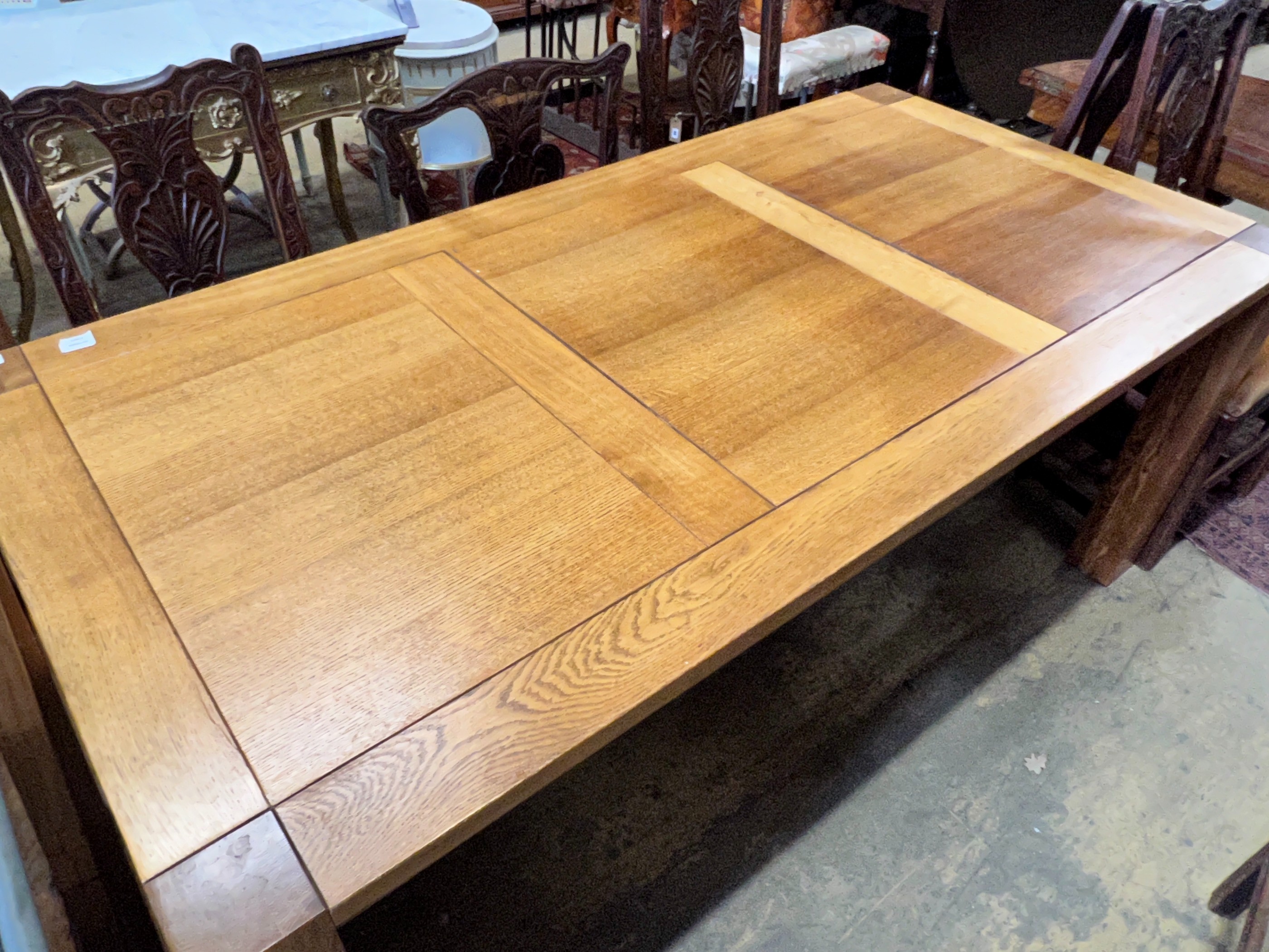 A large contemporary rectangular oak dining table, with removable end leaves, length 280cm extended, width 90cm, height 75cm